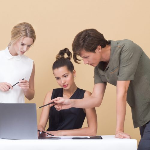 two-woman-and-one-man-looking-at-the-laptop-1036641